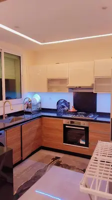 a kitchen with a sink and a stove top oven at شقة مفروشة in Marrakech