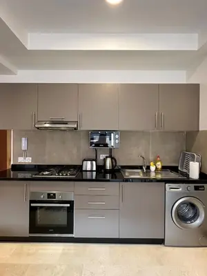 a kitchen with a stove and a sink at Noria Golf Poolside Garden Flat in Marrakech
