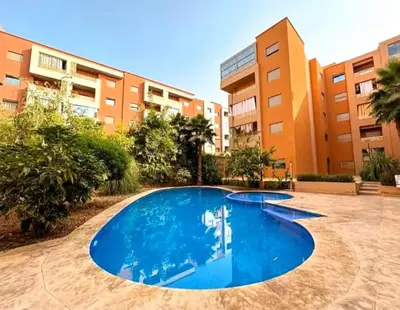 an empty swimming pool in front of a building at Cozy Cove Marrakech in Marrakech