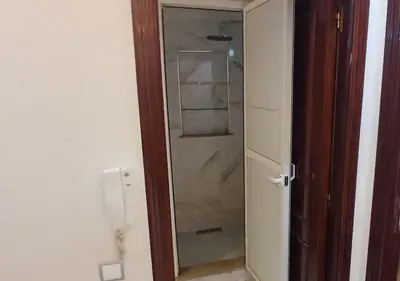 a glass door to a shower in a bathroom at Appart Walili in Marrakech