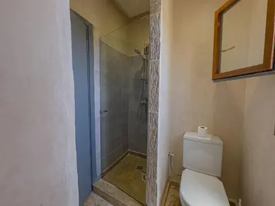 a bathroom with a white toilet and a shower at Riad Tonaroz Gold in Marrakech