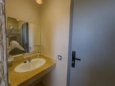 a bathroom with a sink and a mirror at Riad Tonaroz Gold in Marrakech