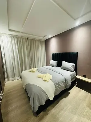 a bedroom with a large bed with two towels on it at 3 bedroom apartment in Marrakech