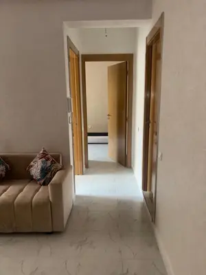 a living room with a couch and a hallway at Sousou Home in Marrakech