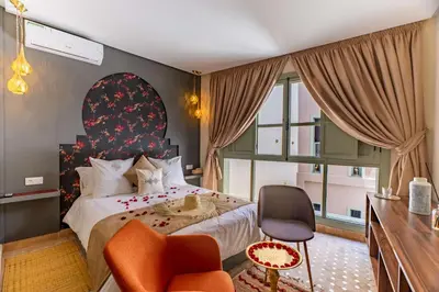 a hotel room with a bed and a chair at Riad 26 in Marrakech