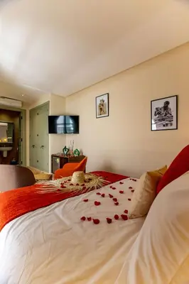 a bedroom with a bed with red roses on it at Riad 26 in Marrakech