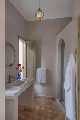 a bathroom with a large sink and a window at Riad Bayda in Marrakech