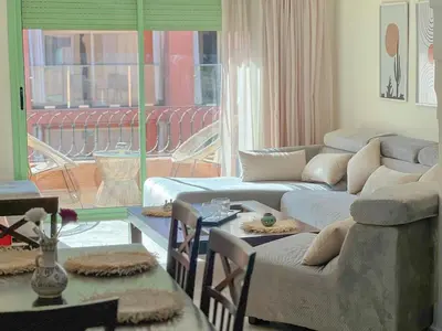 a living room with couches and a large window at Stylish Stay downtown in Marrakech