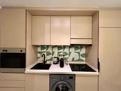 a kitchen with a sink and a washing machine at Eden Vibes GUELIZ in Marrakech
