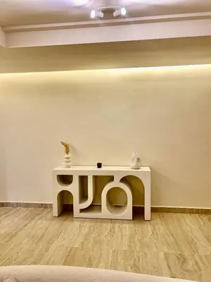 a white table in a room with a white wall at Eden Vibes GUELIZ in Marrakech