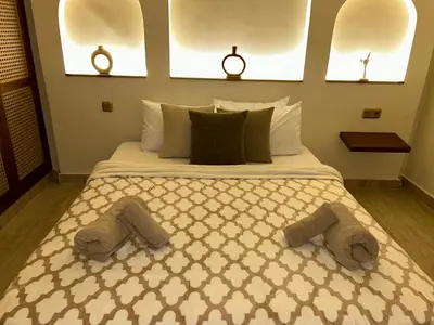 a bedroom with a large bed with two slippers on it at Eden Vibes GUELIZ in Marrakech