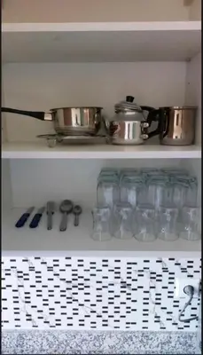 a kitchen shelf with a pot and pans on it at Kech Amal Apartment in Marrakech