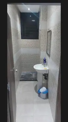 a bathroom with a sink and a shower and a toilet at Kech Amal Apartment in Marrakech