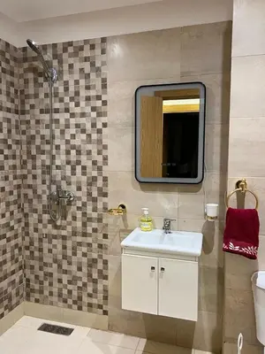 a bathroom with a sink and a mirror at Marrakech Luxe & confort Appartement in Marrakech