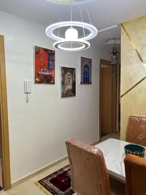 a dining room with a table and some pictures on the wall at Marrakech Luxe & confort Appartement in Marrakech