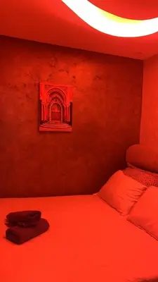 a bedroom with a bed with red lights on it at Marrakech Luxe & confort Appartement in Marrakech