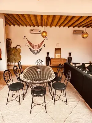 a dining room with a table and chairs at Dar Tal, Marrakech in Douar Oulad Ali