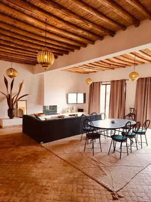 a room with a table and chairs and a kitchen at Dar Tal, Marrakech in Douar Oulad Ali
