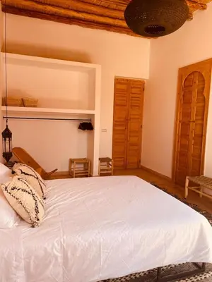 a bedroom with a white bed in a room at Dar Tal, Marrakech in Douar Oulad Ali