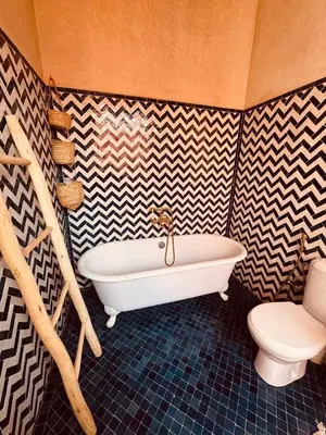 a bathroom with a tub and a toilet at Dar Tal, Marrakech in Douar Oulad Ali