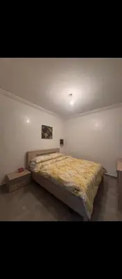 a bedroom with a large bed in a room at Appartement calme chez Nawal in Marrakech