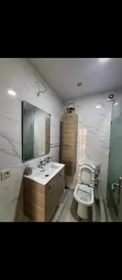 a bathroom with a toilet and a sink and a mirror at Appartement calme chez Nawal in Marrakech