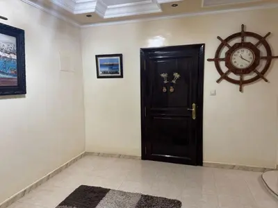 a room with a door and a clock on the wall at Al acadimya in Marrakech