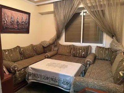 a living room with a couch with a table on it at Al acadimya in Marrakech