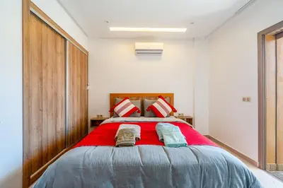 a bedroom with a large bed with two pillows at Warm Nest 5 Central And Peaceful in Marrakech