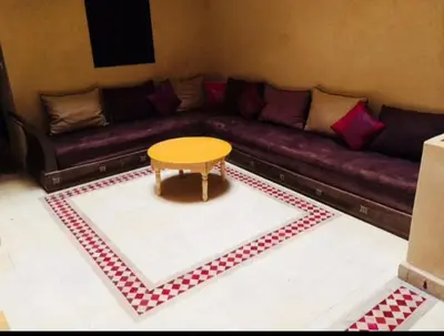 a living room with a couch and a table at Riad Marrakech - Piscine -Wifi- résidence qarya essyahia in Marrakech