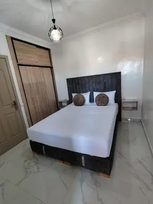 a bedroom with a large white bed with two pillows at Marrakech Riad in Marrakech