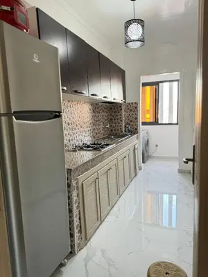 a kitchen with a stainless steel refrigerator and cabinets at Marrakech Riad in Marrakech