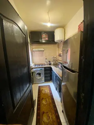 a small kitchen with a refrigerator and a stove at Marrakech Gateway in Oulad Akkou