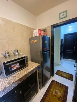 a kitchen with a refrigerator and a counter top at Marrakech Gateway in Oulad Akkou