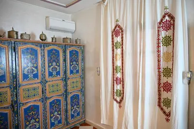 a room with a colorful cabinet and a curtain at dar sarsar airport 2 in Marrakech