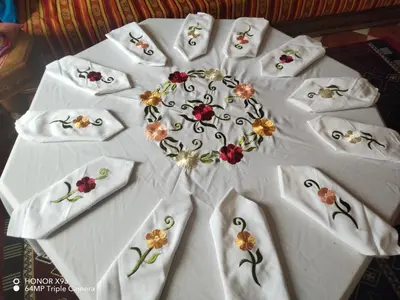 a white table topped with white napkins with flowers on it at dar sarsar airport 2 in Marrakech