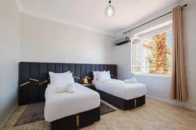 a bedroom with two beds and a window at Villa 4 bedrooms with private pool in Marrakech in Marrakech