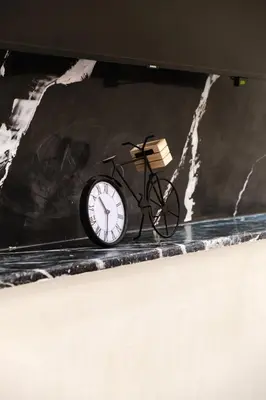 a black clock sitting on top of a table at Villa 4 bedrooms with private pool in Marrakech in Marrakech