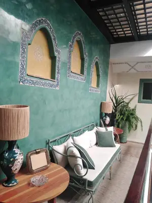 a living room with a bed and a table at Riad Dar Nana in Marrakech