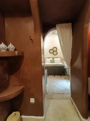 a room with a bedroom with a bed and a door at Riad Dar Nana in Marrakech