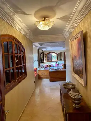 a living room with a table and a living room at Villa floor Espace ouvert in Marrakech