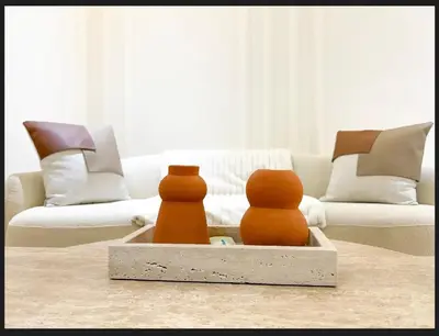two objects in a tray in a living room at Triplex De Luxe Ocra piscine privée in Marrakech