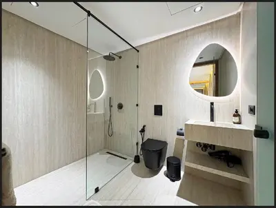 a bathroom with a shower and a sink and a mirror at Triplex De Luxe Ocra piscine privée in Marrakech