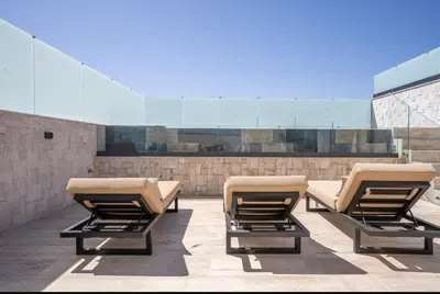 a row of chaise lounge chairs on a patio at Triplex De Luxe Ocra piscine privée in Marrakech
