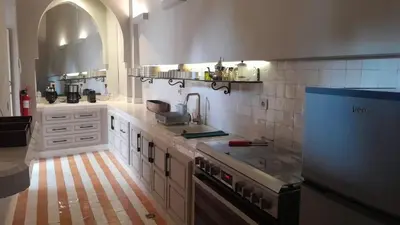 a kitchen with a sink and a stove top oven at Riad Djannaat Exceptional private riad pool staff in Marrakech