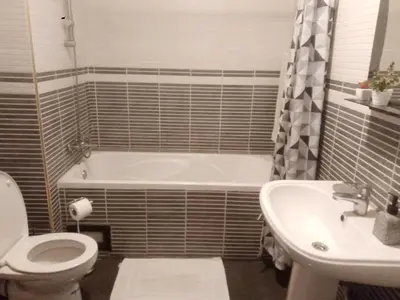 a bathroom with a tub and a toilet and a sink at Appartement en plein centre in Marrakech
