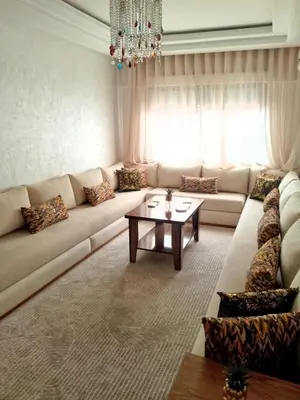 a living room with a couch and a table at Appartement en plein centre in Marrakech