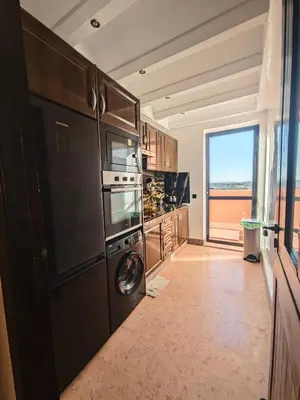a kitchen with a washer and dryer at Ennaim in Marrakech