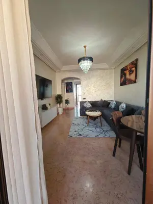 a living room with a couch and a table at Ennaim in Marrakech