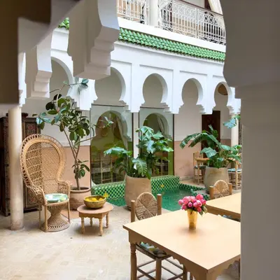 a courtyard with tables and chairs in a building at Riad Tecla in Marrakech